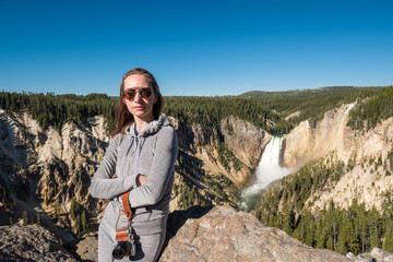 Tourist overlooking waterfall in Yellowstone