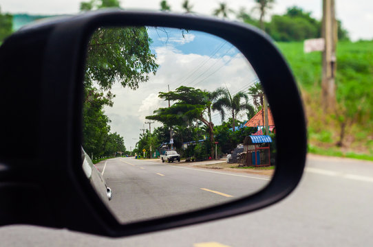 Street view into Side mirror of car