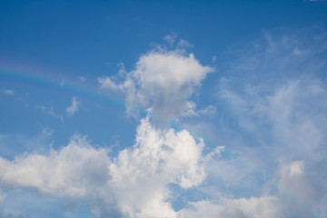 Naklejka na ściany i meble Natural real rainbow with cloud in blue sky background
