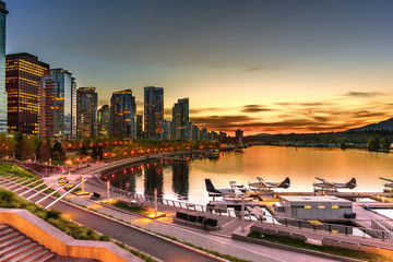 Night life of a huge seaside metropolis with modern brilliant multi colored neon lights of...