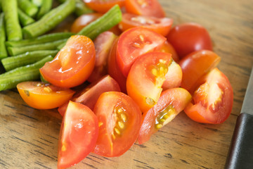 red ripe tomatoes sliced on cutting board for cooking in closeup