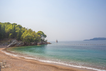 A deserted sandy beach among the beruze water.