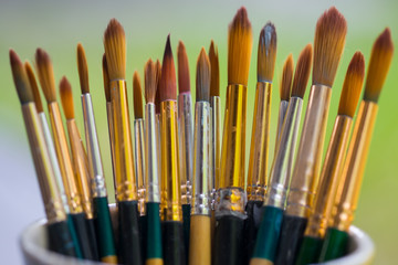 Paintbrush against green background