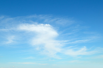 Light cirrus clouds and blue sky.