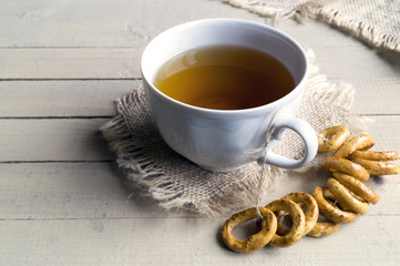 Tea in a white Cup with crackers.