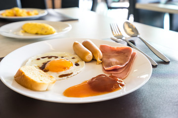 breakfast meal with sunny egg and omelet on table