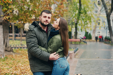Young loving couple on a city street . Romantic couple in autumn city walk