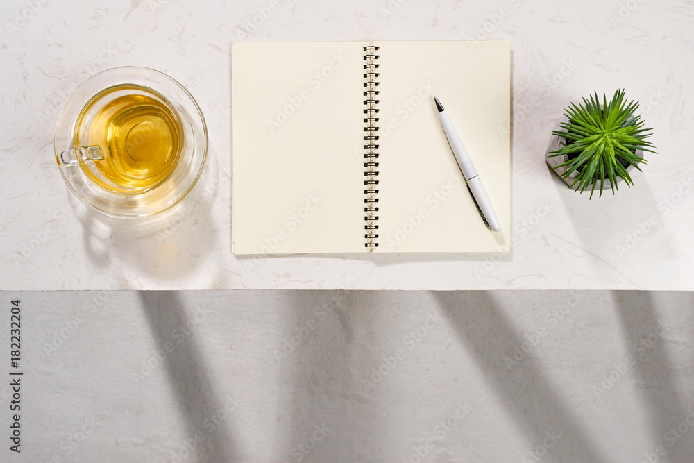 Poster blank opened notebook with teacup on table. writing concept.