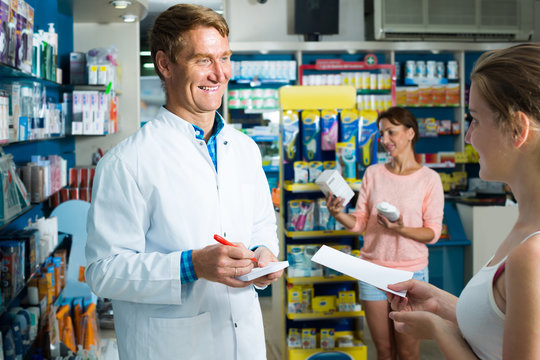man pharmacist in pharmaceutical shop .