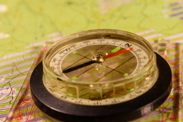 Magnetic compass lying on topographical map