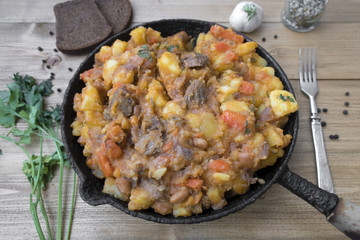 stewed vegetables with beans and meat in a frying pan