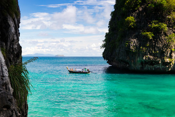 Tropical landscape with rock islands lonely boat and crystal clear.