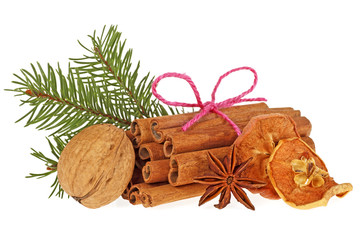 Fir tree branch, dried apple, anise, walnut and cinnamon sticks on white background