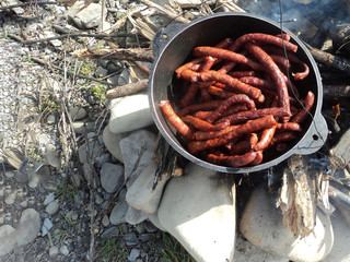 BBQ with fiery sausages on the grill