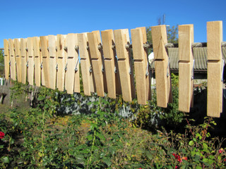 a lot of clothes pegs on the rope