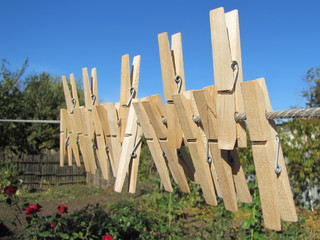 a lot of clothes pegs on the rope
