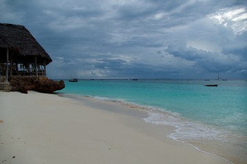 romantic sunset with a boat on the ocean