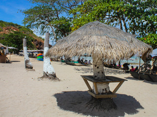 Fototapeta premium Natural straw umbrella on beautiful beach