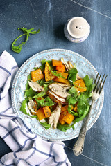 Pumpkin salad with chicken and arugula.Top view.