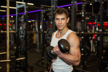 Fototapeta premium Young muscular man in gym
