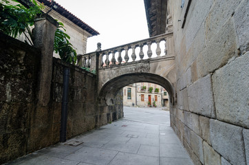 Fototapeta na wymiar Romanic small arch bridge crossing over the street in Pontevedra Spain