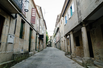 Empty street in town's historic quarter Pontevedra (Spain). Masonry walls and stone columns. Horizontal