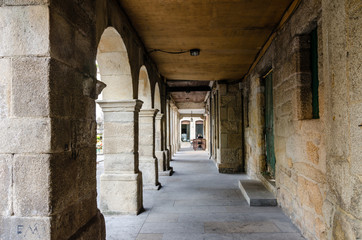 Street corridor in Pontevedra historic center. Columns and closed stores