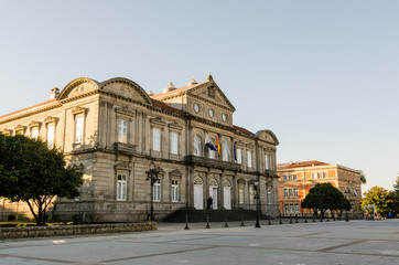 Fototapeta na wymiar Facade of Deputacion Provincial of Pontevedra (Spain) with flags