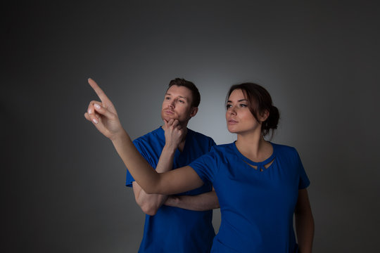 Doctors pointing to something