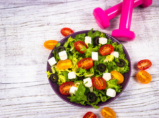 Greek salad with fresh vegetables, feta cheese and black olives.