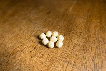 Fototapeta na wymiar Pale yellow spherical tablets of probiotics with prebiotics