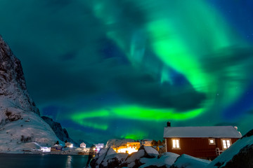 Northern Lights above the Snow-Covered Houses