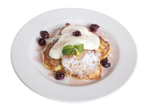Pancakes with sour cream and cherries.