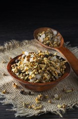 A mixture of herbs and spices in a wooden on a burlap background with copy space for your text