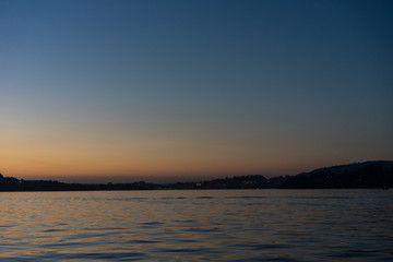 sunset on lake lucerne with mountains viewed from boat clear sky