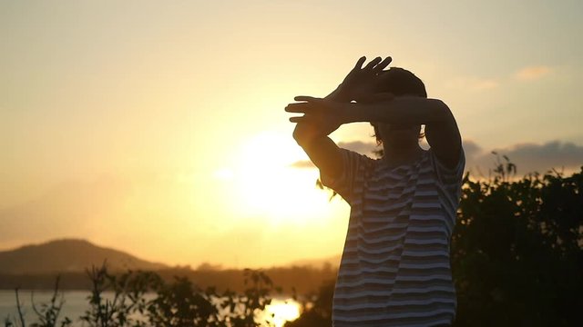Freedom in the dance at amazing Sunset. Man rising hands to the air in slow motion. 1920x1080