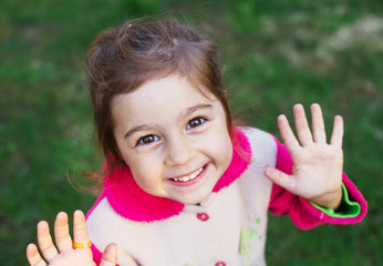 Close up portrait of happy little girl smiling to the camera
