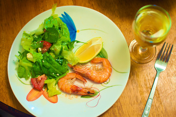 two shrimps in carapace, green salad