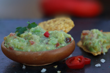 Traditional latinamerican mexican avocado sauce guacamole with tortilla chips