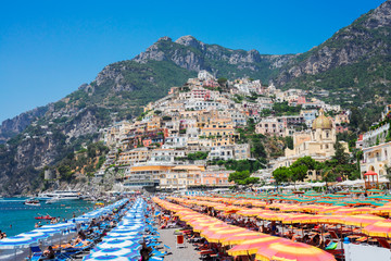 Sea and row of umbrellas on beach of Positano - famous old italian resort, Italy - obrazy, fototapety, plakaty