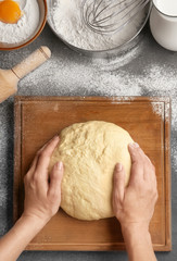 Female chef with dough on kitchen table