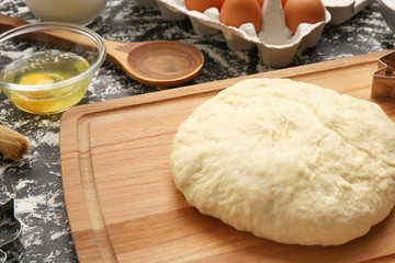 Raw dough on wooden board