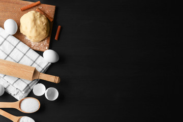 Raw dough with ingredients on kitchen table