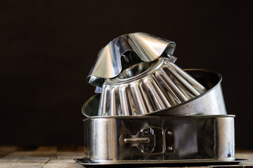 Old baking molds on an old kitchen table. Baking accessories in the kitchen.