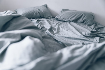 Empty messy gray bed