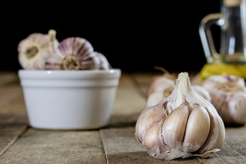 Tasty garlic on a wooden kitchen table. Vegetables in the kitchen atmosphere. Wooden table.
