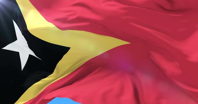 Flag of East Timor waving at wind with blue sky in slow, loop
