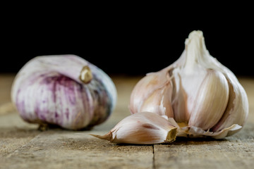Tasty garlic on a wooden kitchen table. Vegetables in the kitchen atmosphere. Wooden table.