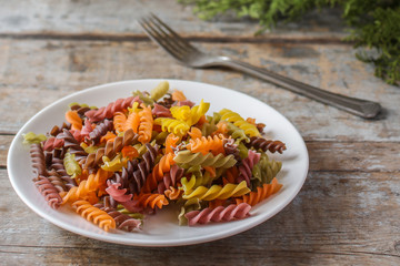Fusilli colored pasta in a white plate - serving (colorful pasta)