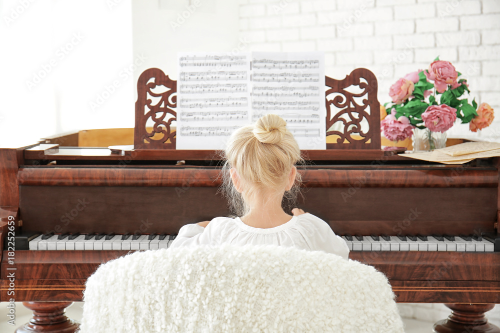 Sticker little girl playing piano indoors